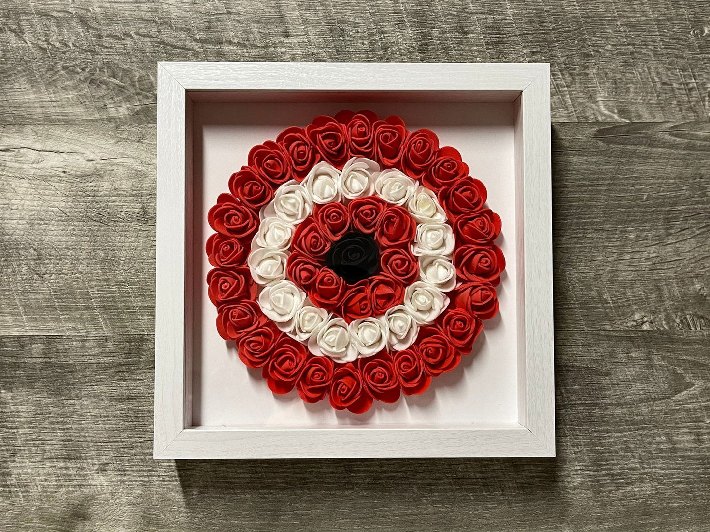 Handmade evil eye rose shadowbox with red and white coil rosette in white frame