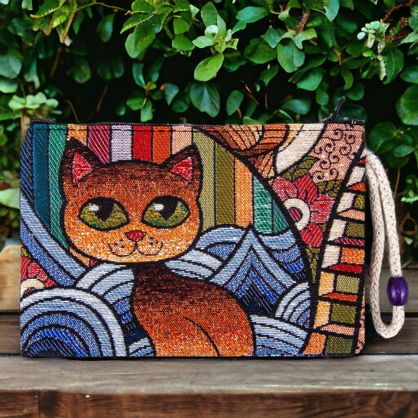 Colorful woven cat art zipper clutch pouch with geometric patterns and purple zipper pull