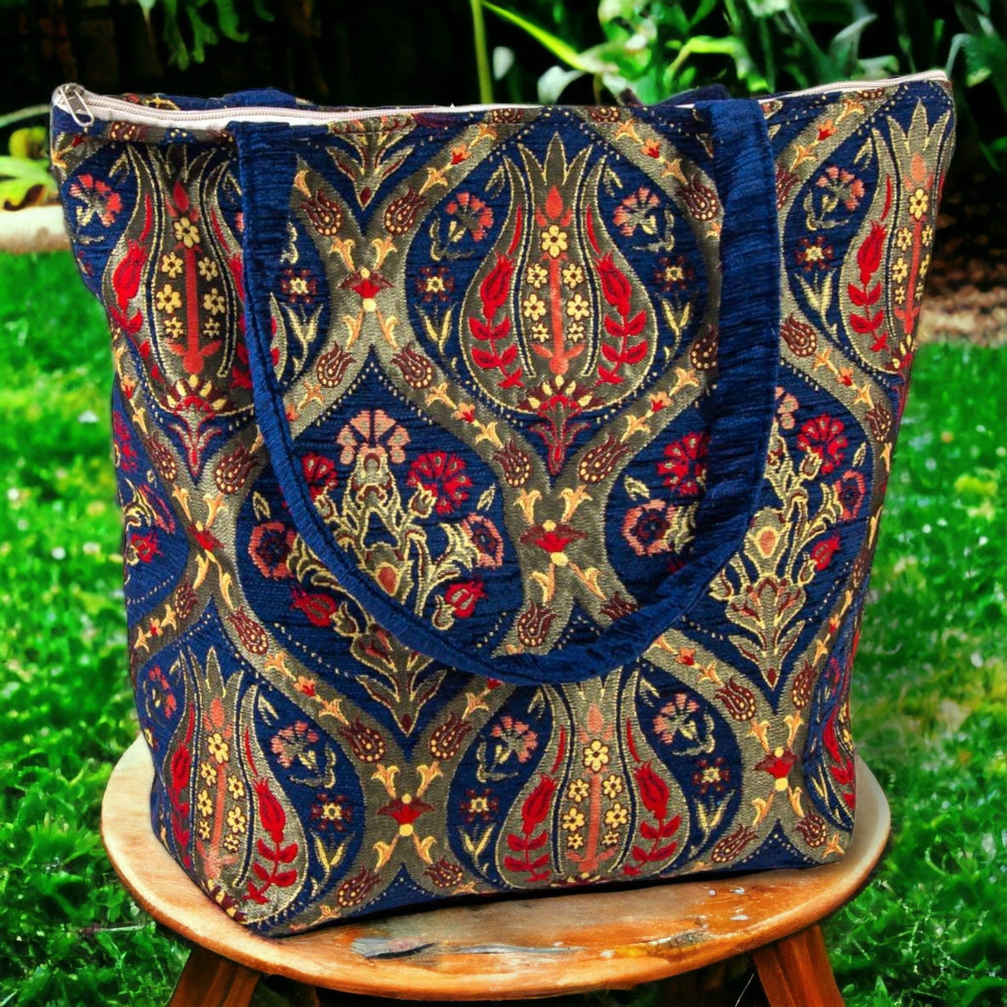 Blue kilim fabric tote bag with ornate gold and red pattern and side handles