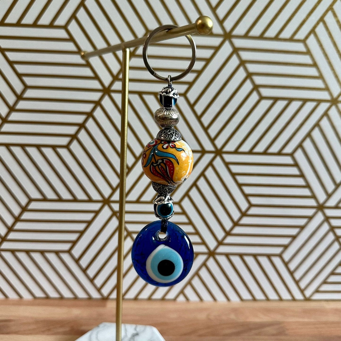 Evil eye keychain with gold ring and stacked blue and orange evil-eye charms