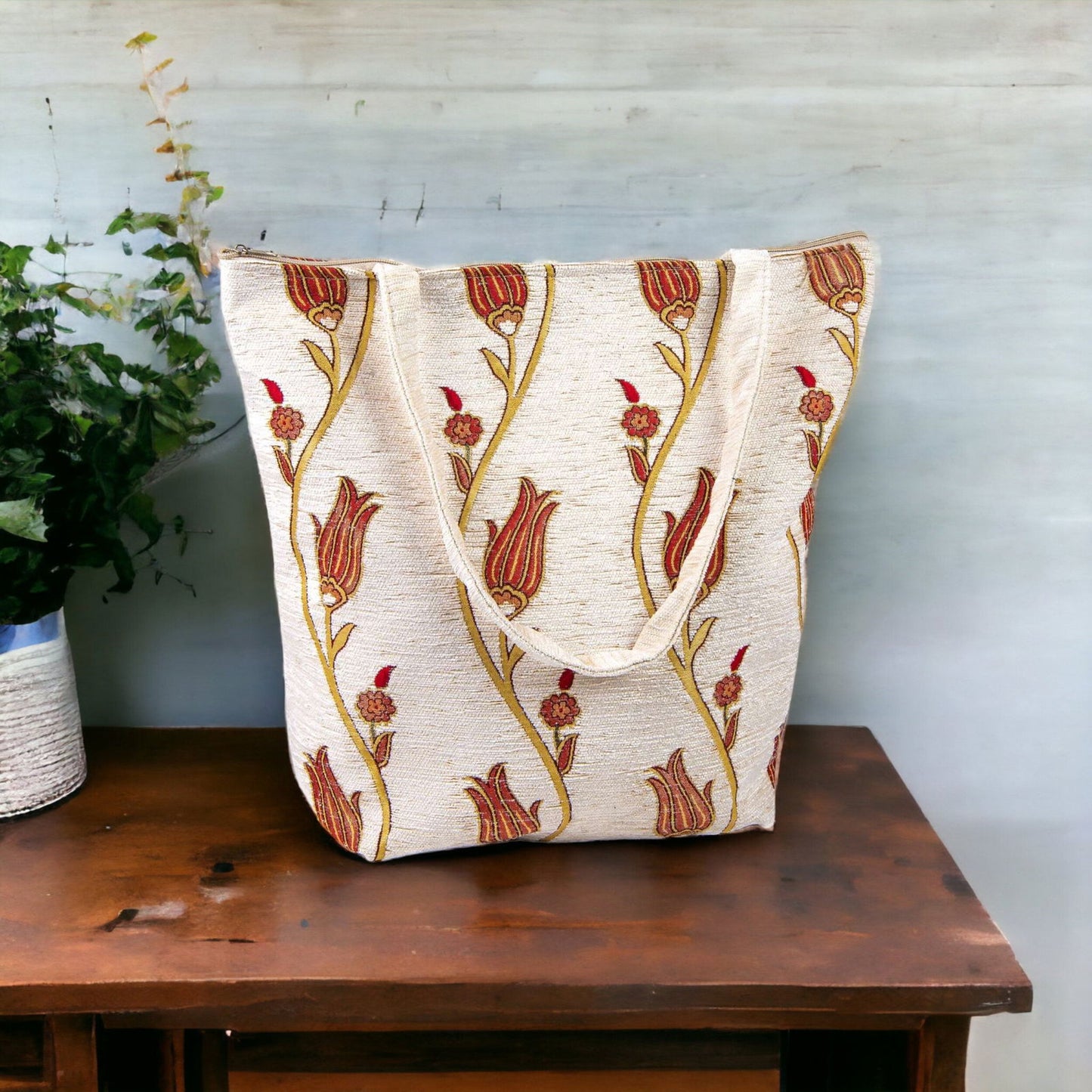 Embroidered tote bag with tulip motif on cream fabric, red and orange accents, fabric handles