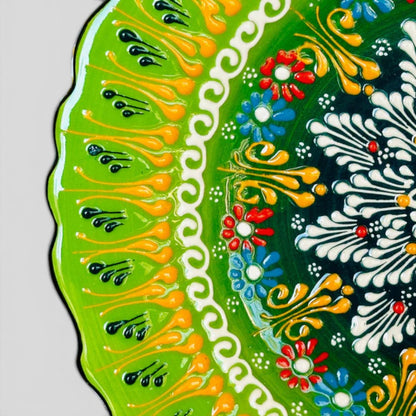 Hand-painted ceramic plate detail, bright green scalloped rim with floral tulip accents