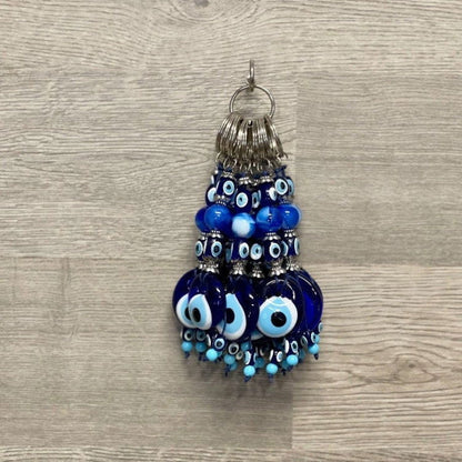 Handcrafted blue glass evil eye keychain with round charm and stacked bead tassel