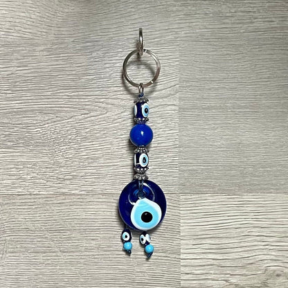 Handcrafted blue glass evil eye keychain with large round eye charm and small bead dangles