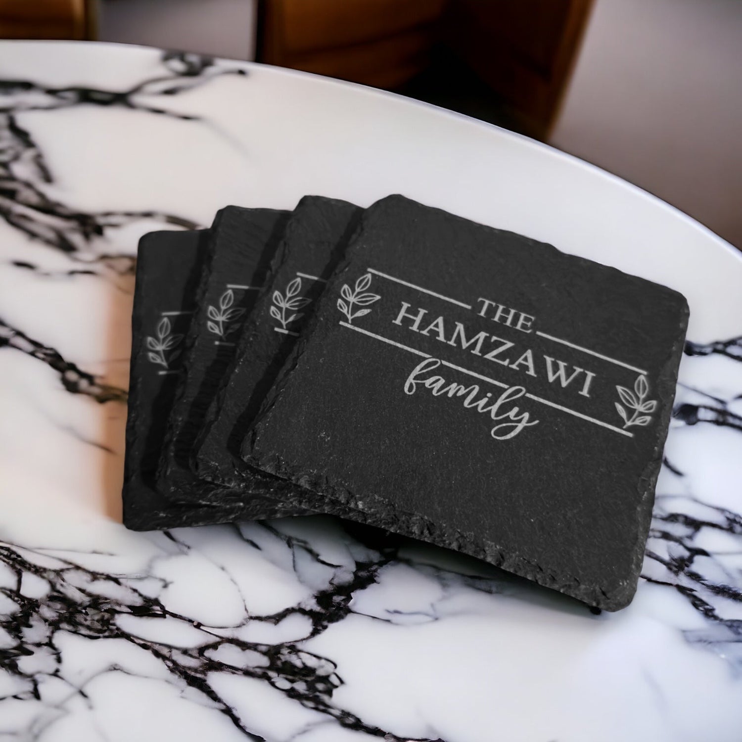 Slate coaster set with engraved "THE HAMZAWI family" on stacked coasters