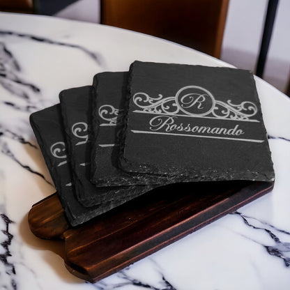 Stack of slate coasters with engraved Rossomando logo