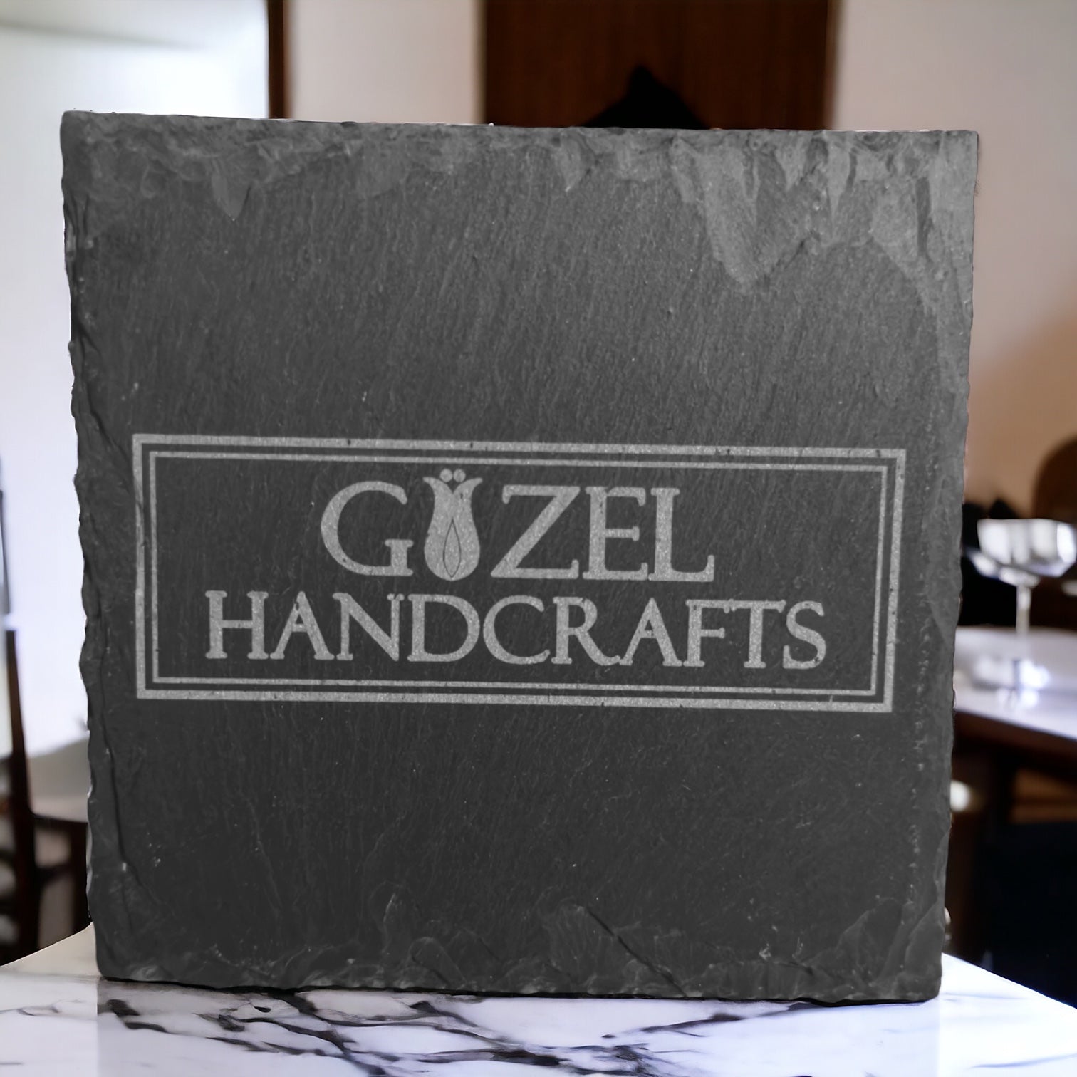 Square slate coaster with engraved GÜZEL HANDCRAFTS logo