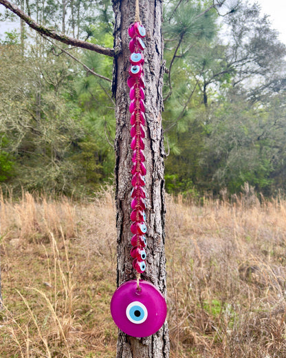 Pink macrame evil eye wall hanging with dangling beads