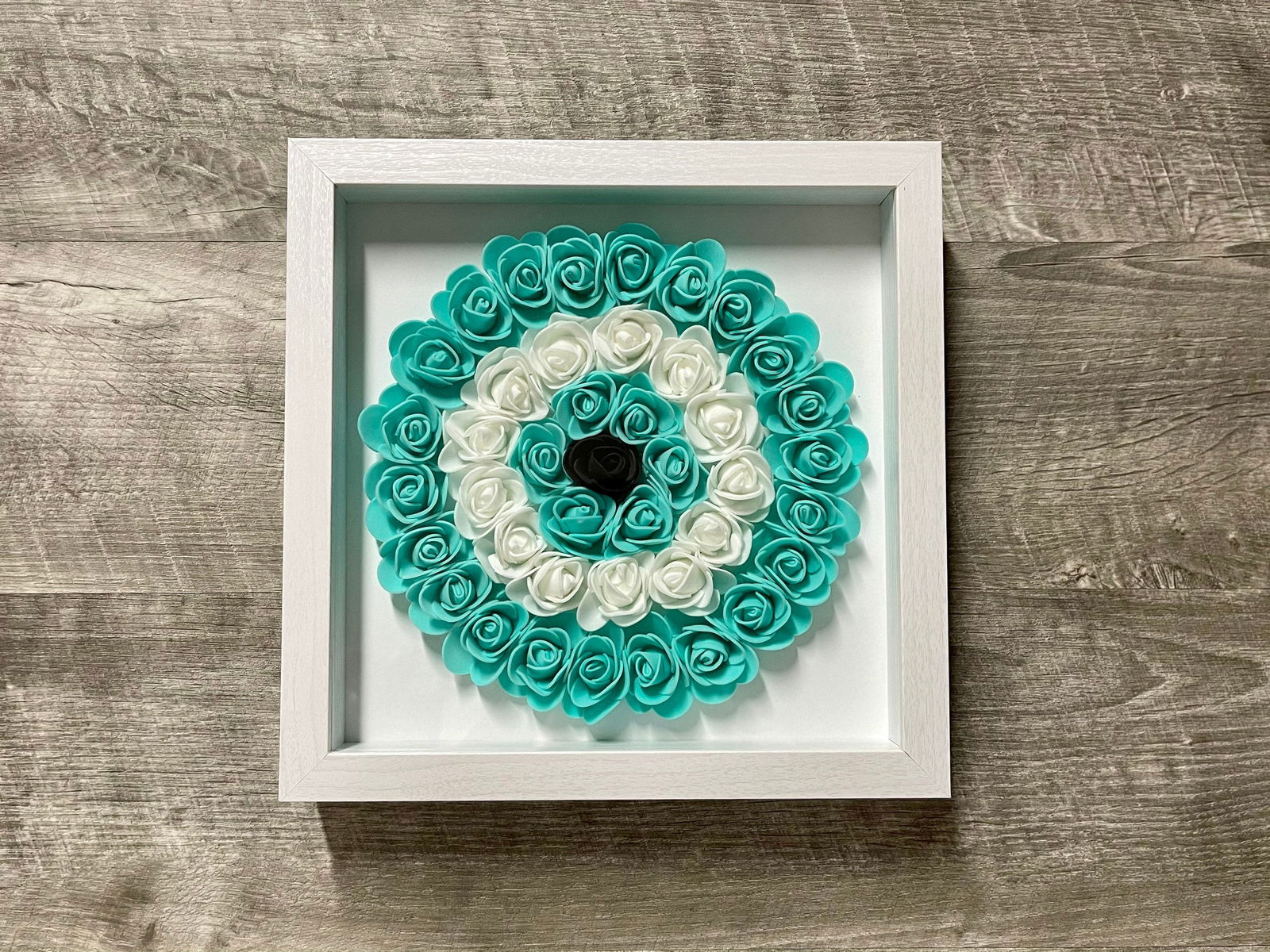 Handmade evil eye rose shadowbox with purple and white coil rosette in white frame