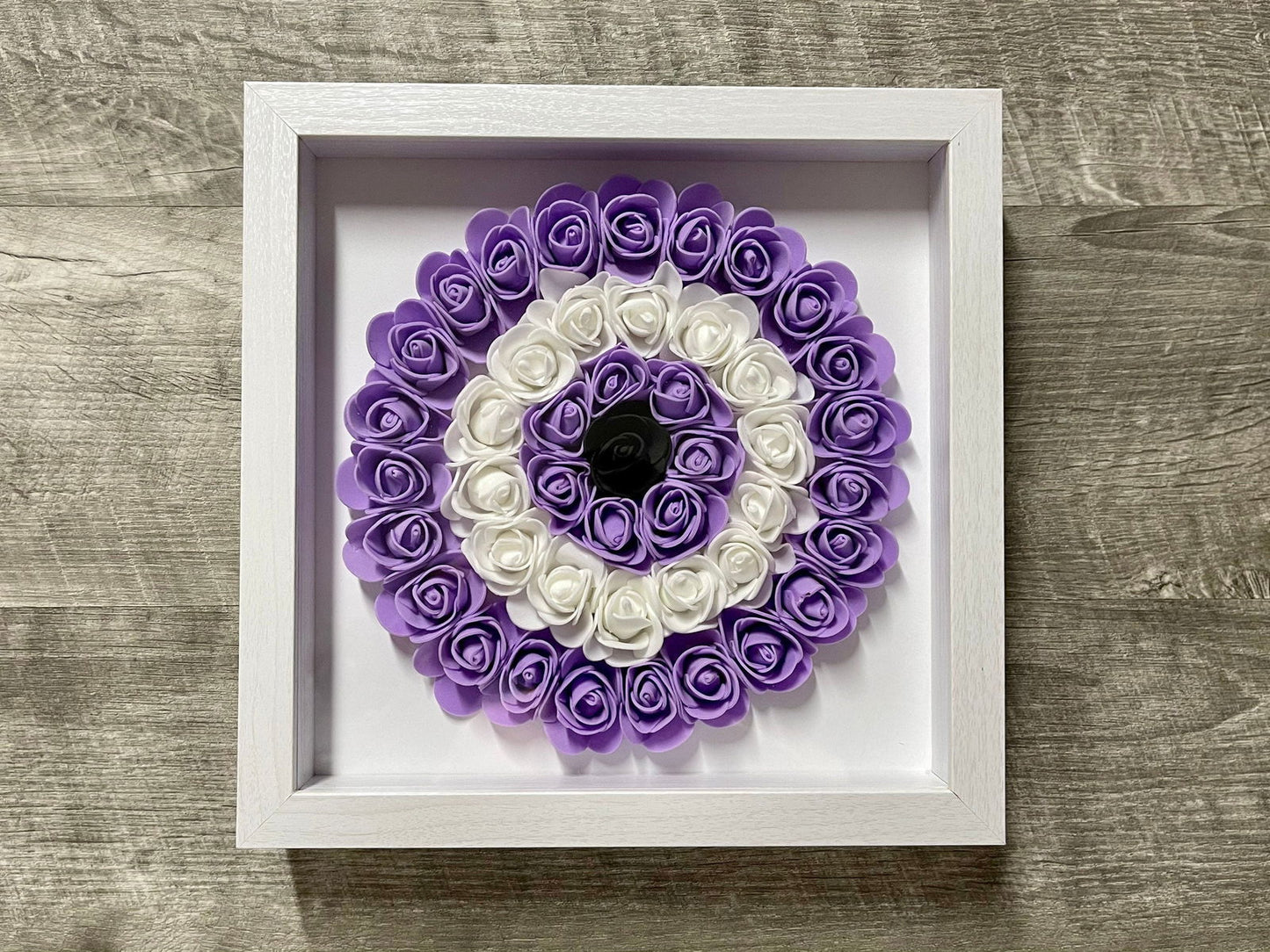 Handmade evil eye rose shadowbox with green and white coil rosette in white frame