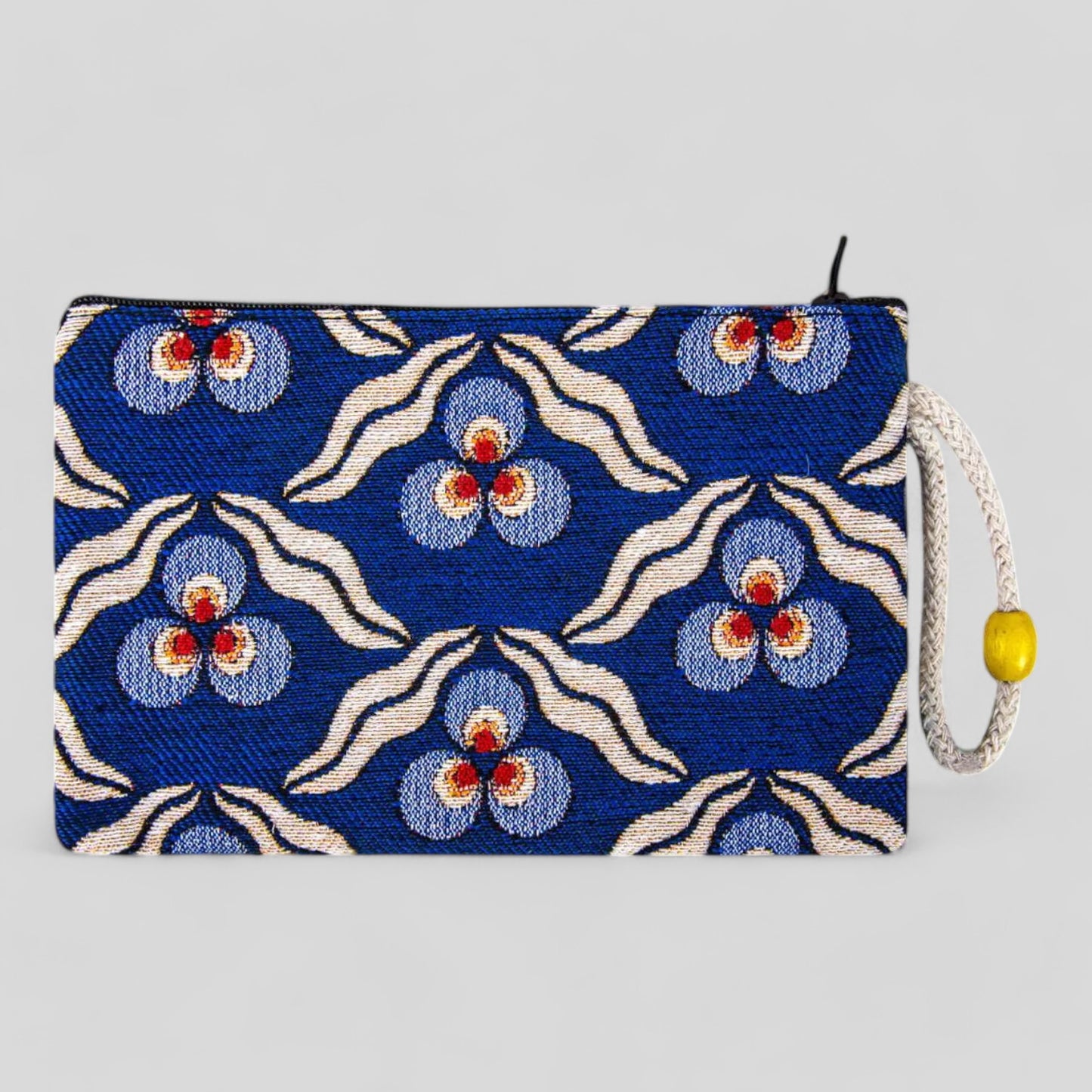 Blue zippered clutch purse with floral evil eye pattern and wrist strap, tassel pull