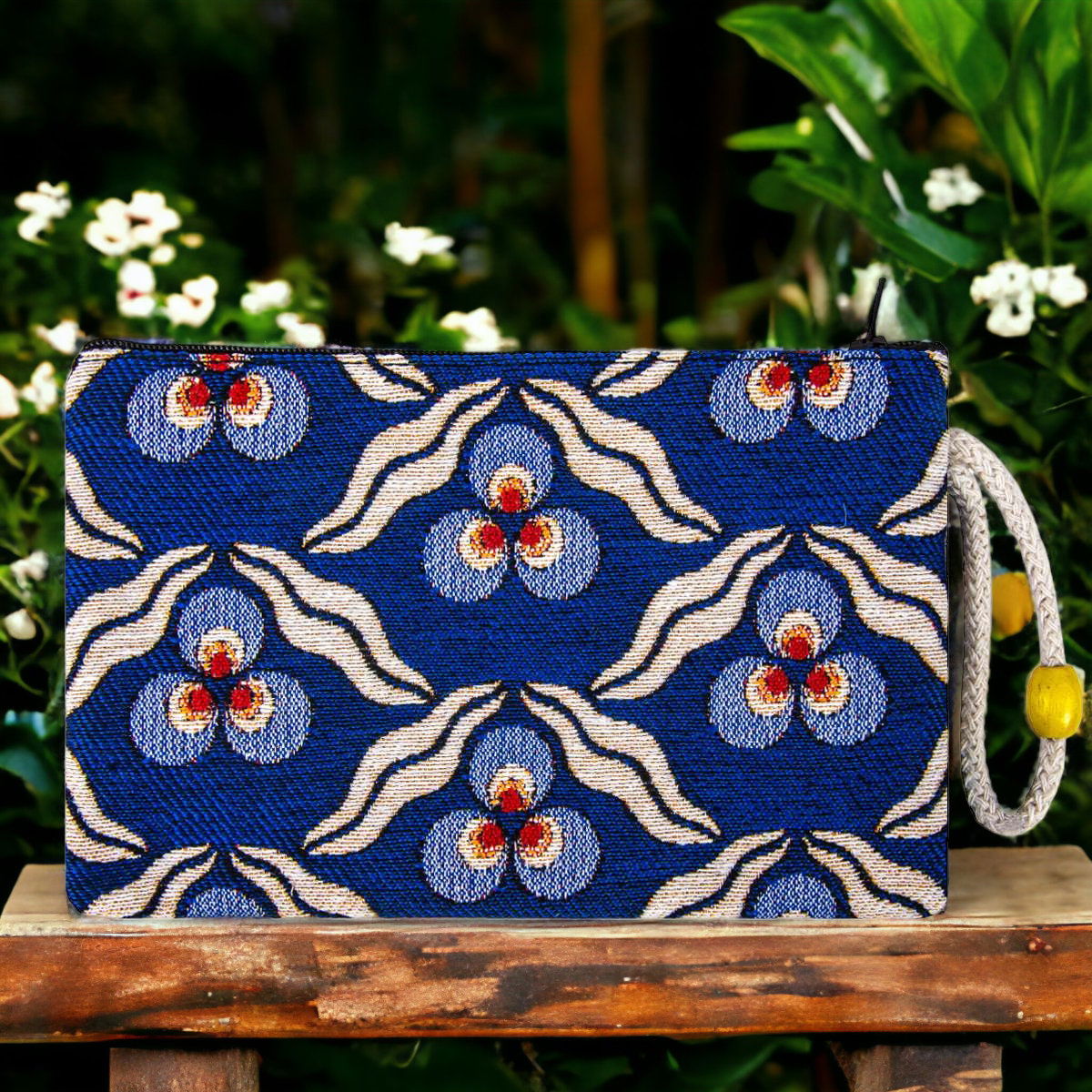 Blue kilim fabric zipper clutch pouch with floral evil-eye berry motif and cord pull