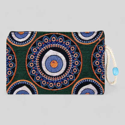 Green kilim clutch purse with blue and orange evil eye mandala, zipper top and cord pull