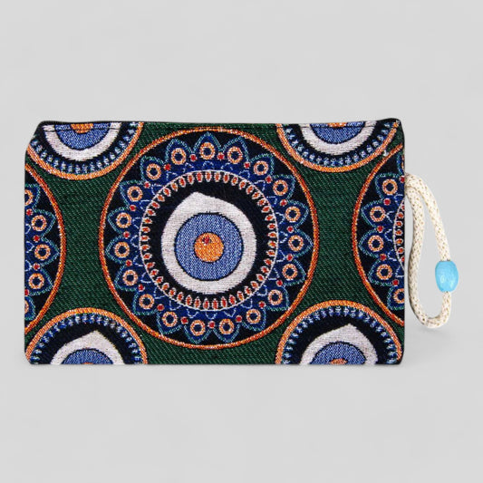 Green kilim clutch purse with blue and orange evil eye mandala, zipper top and cord pull
