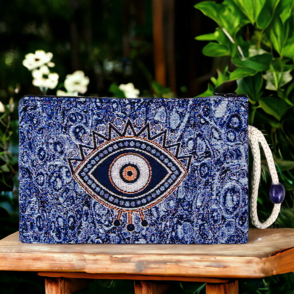 Blue evil eye patterned zip pouch with central eye motif