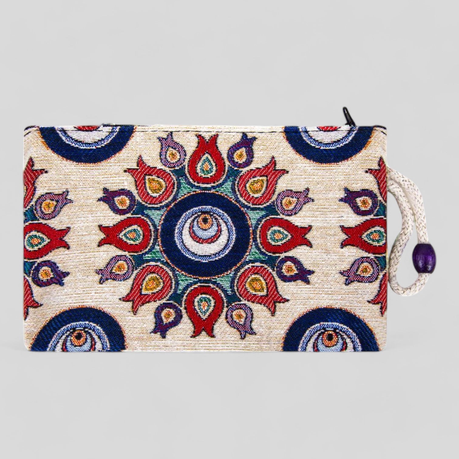 Kilim fabric zipper pouch with blue and red evil-eye and tulip motifs, tassel pull