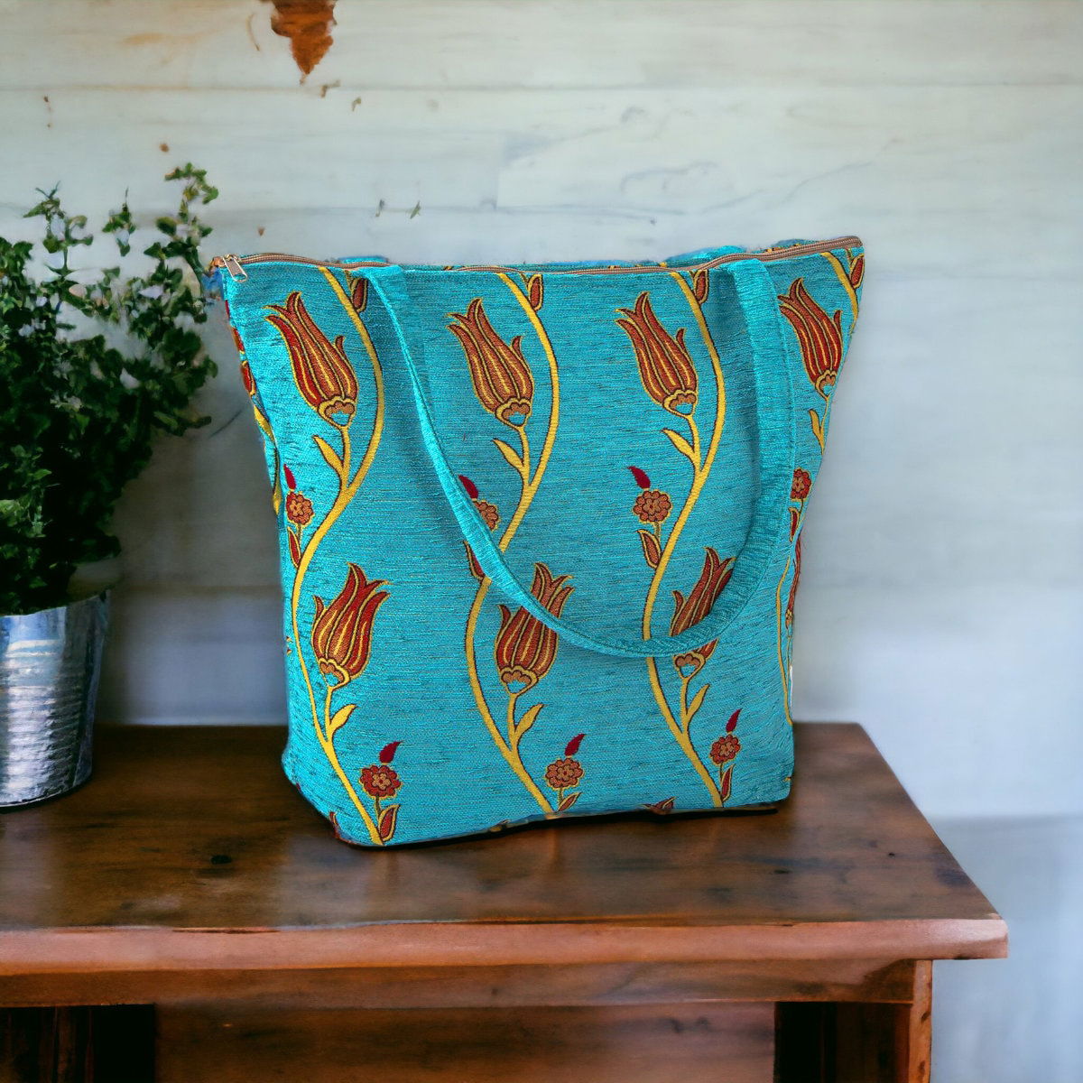 Turquoise kilim tote bag with gold tulip-like pattern and side handles