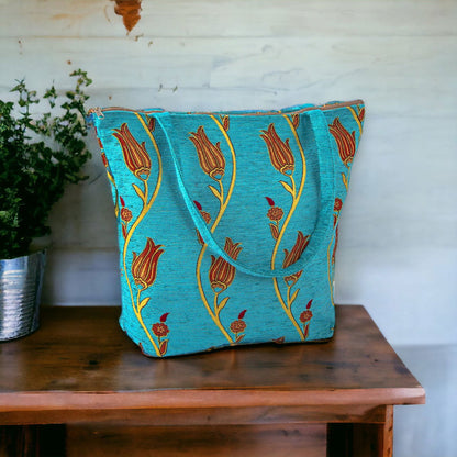 Turquoise kilim tote bag with gold tulip-like pattern and side handles