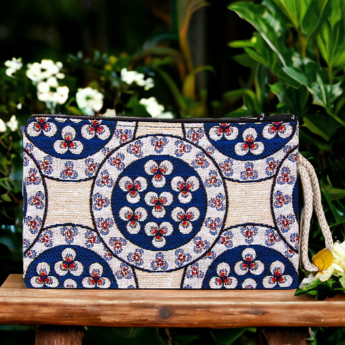 Blue and white circular motif zipper pouch clutch with wrist strap