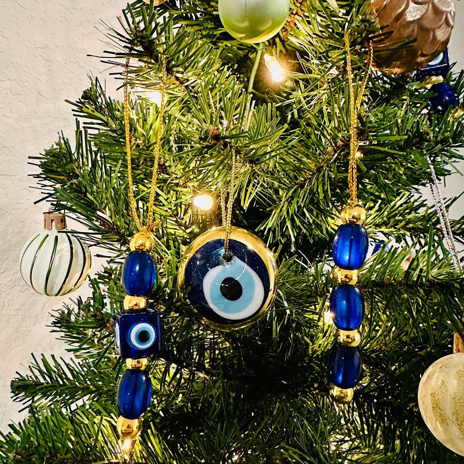 Blue-and-gold evil eye ornaments with round eye discs and bead tassel hangers