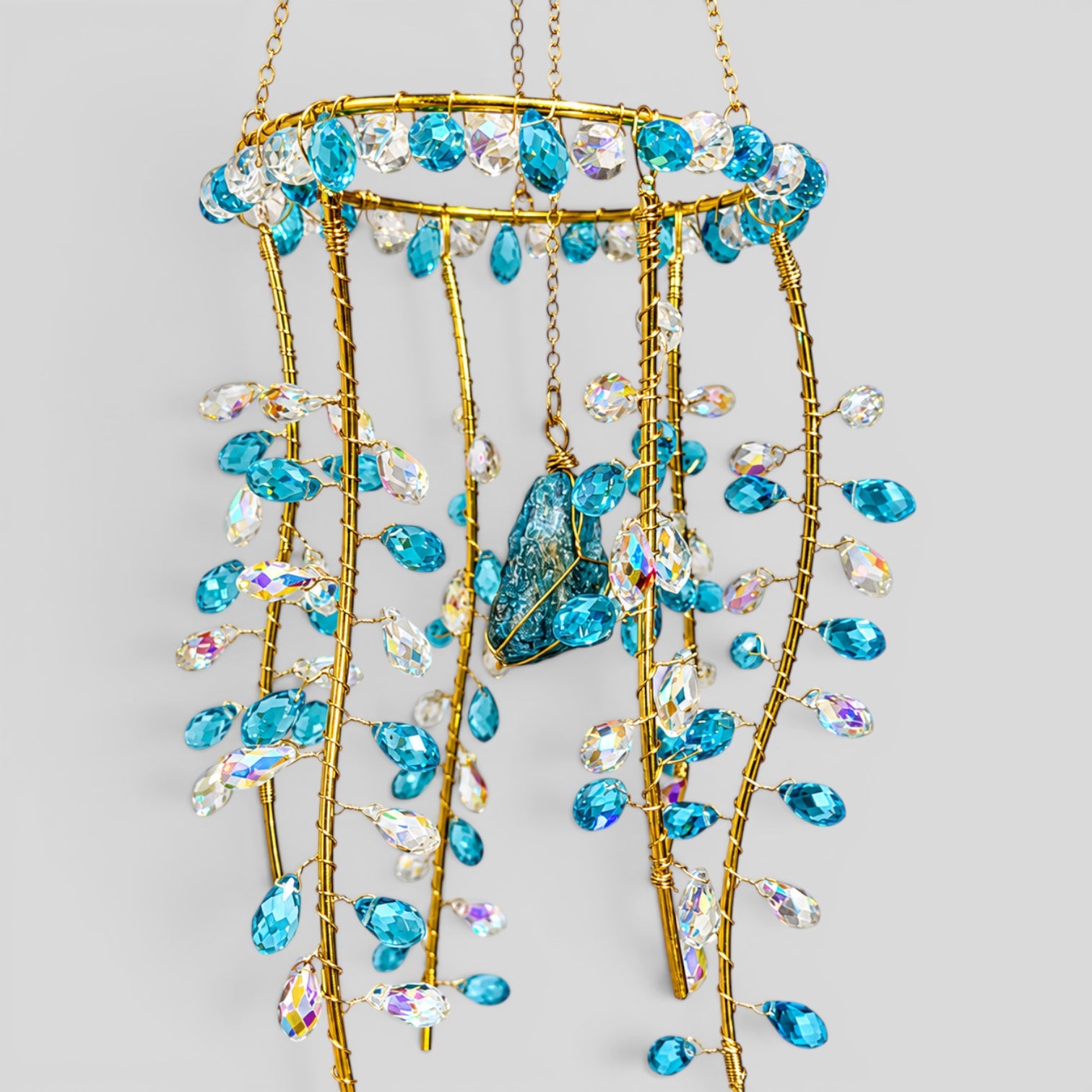 Gold hanging suncatcher with long bead strands and blue jellyfish center