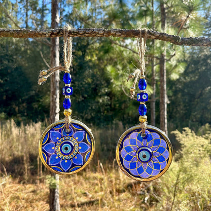 Dual-layer blue evil eye wall hanging with gold trim; two round mandala discs and beads