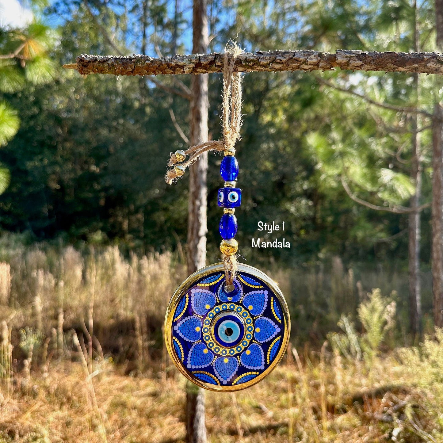 Round blue evil eye wall hanging with gold trim, mandala dotwork disc and hanging beads