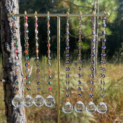 Evil eye rearview mirror charm with gold chain strands, multicolor beads, and crystal discs