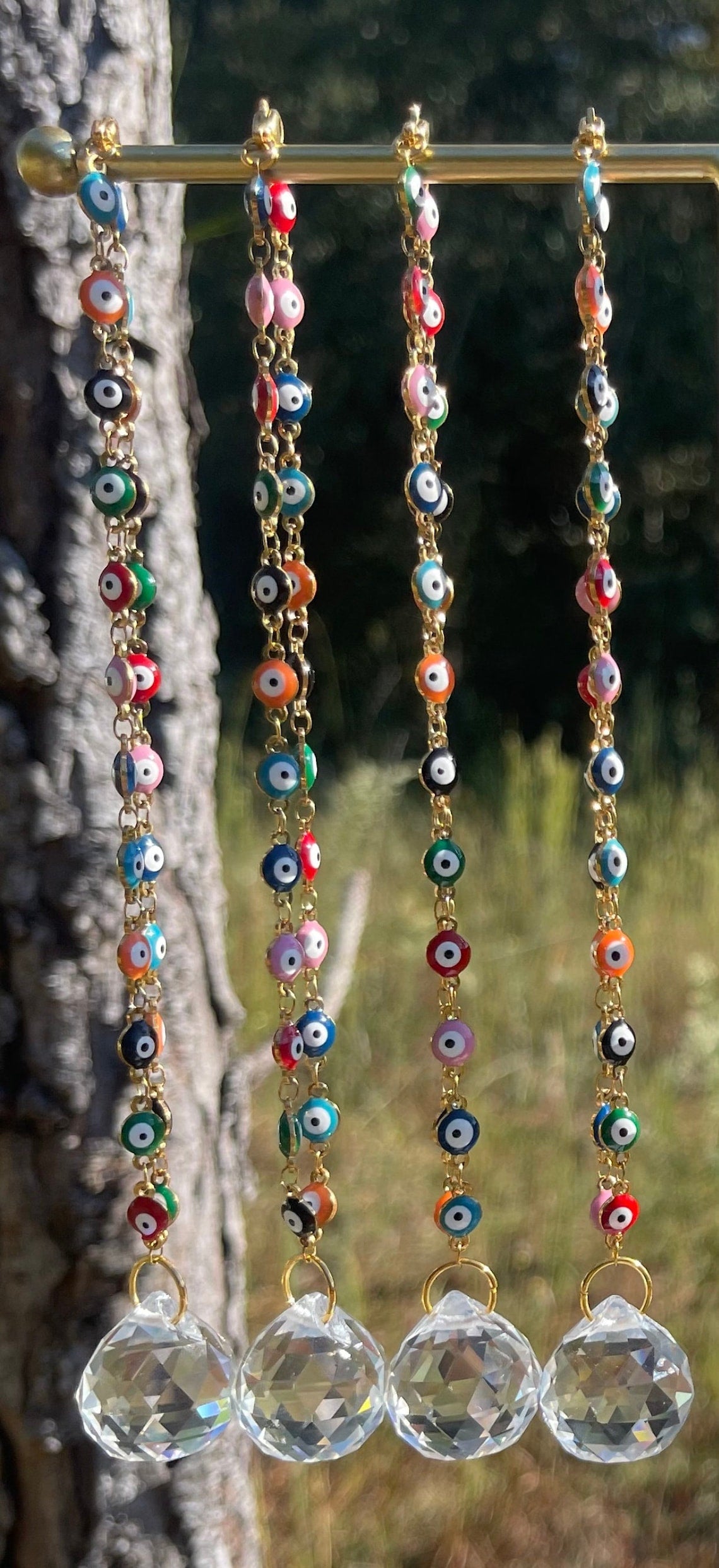 Evil eye rearview mirror charm with gold-toned beads and clear crystal disc suncatchers