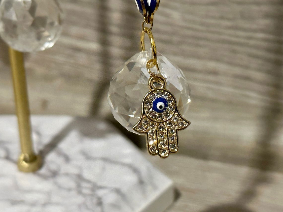 Gold evil eye hamsa rearview mirror charm with blue eye and clear crystal disc bead