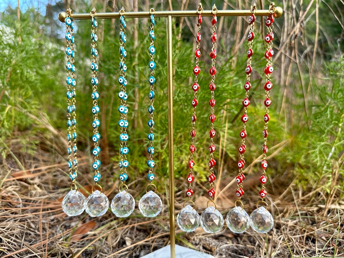 Evil eye rearview mirror charm with gold chain strands, multicolor and red beads, crystal discs