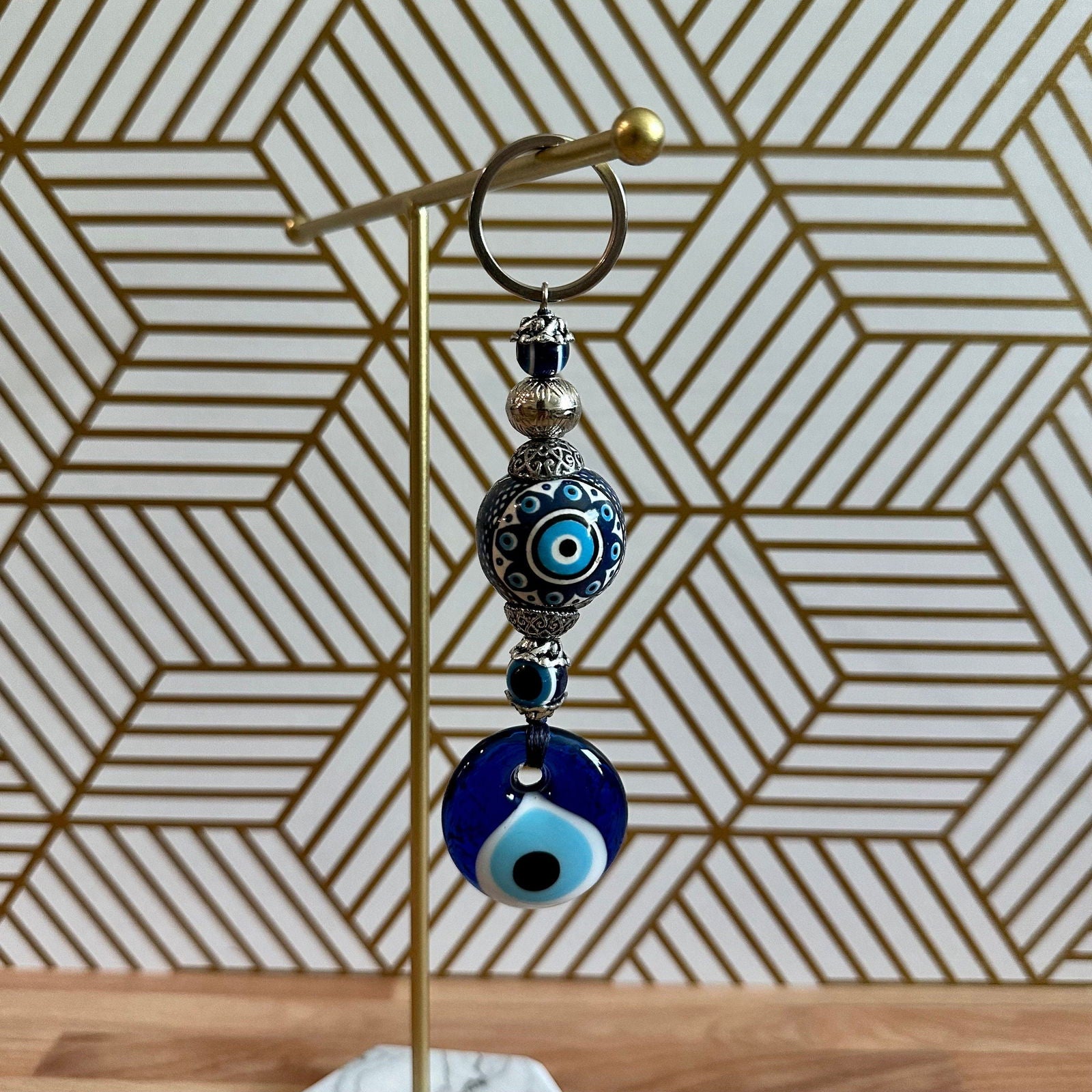 Blue evil eye ceramic ball keychain with metal ring and dangling bead charms