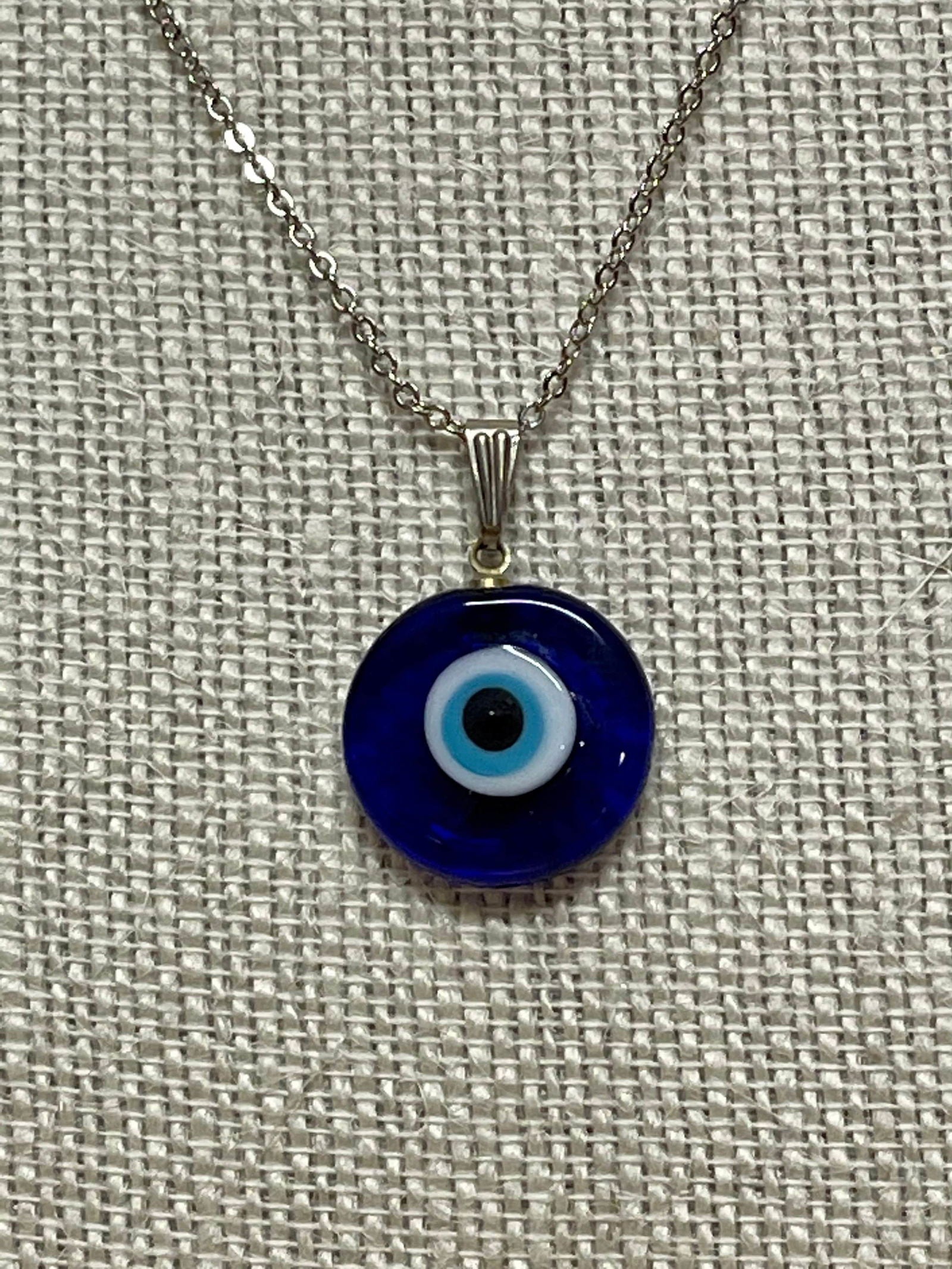 Evil eye pendant necklace charm with dark blue round bead and silver chain