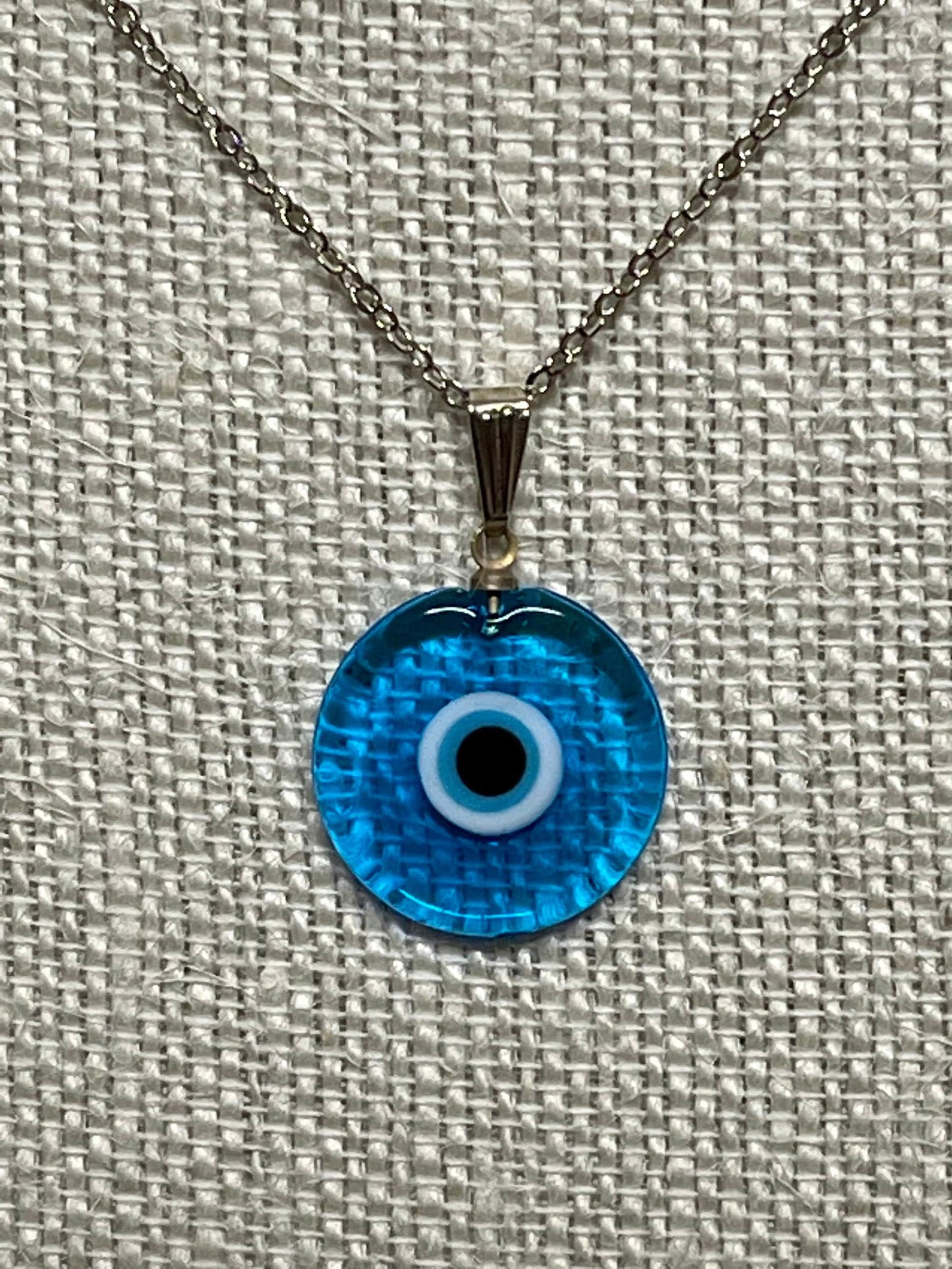 Bright blue evil-eye pendant necklace with silver chain and round glass charm