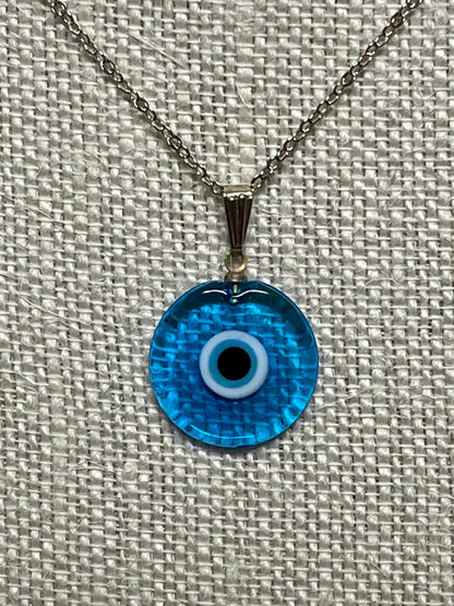 Bright blue evil-eye pendant necklace with silver chain and round glass charm