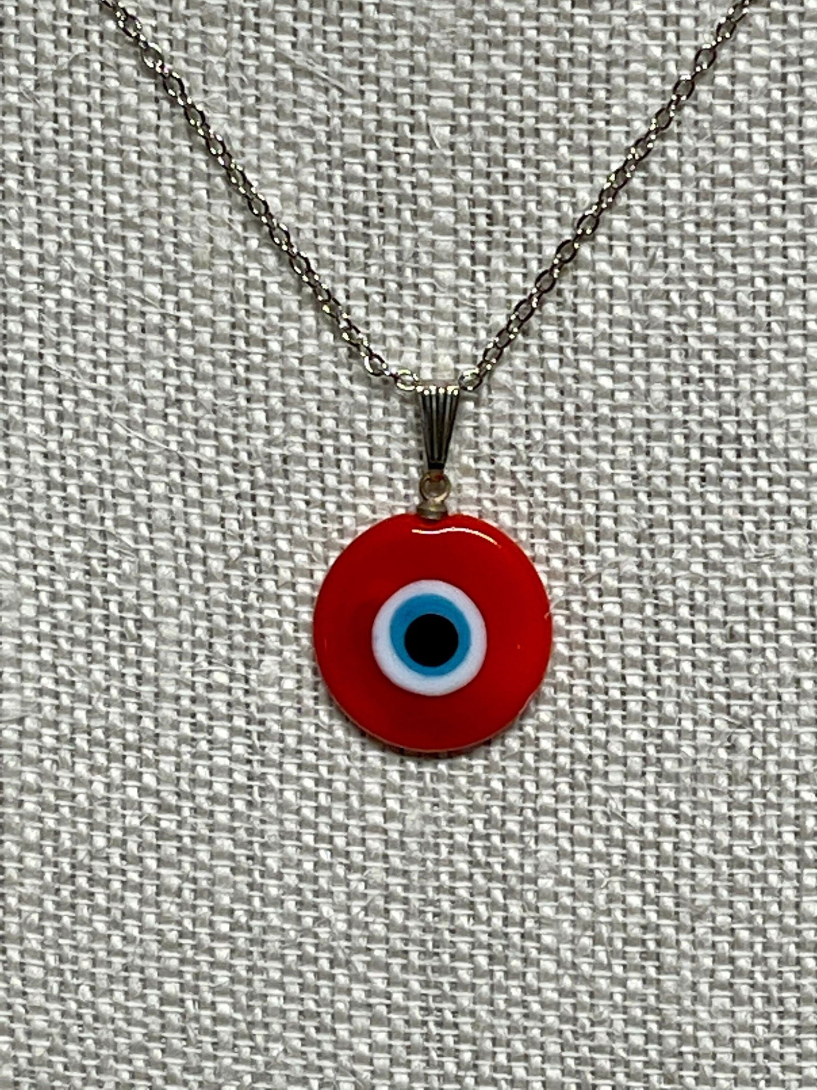 Red evil-eye pendant necklace with silver chain and round glass charm