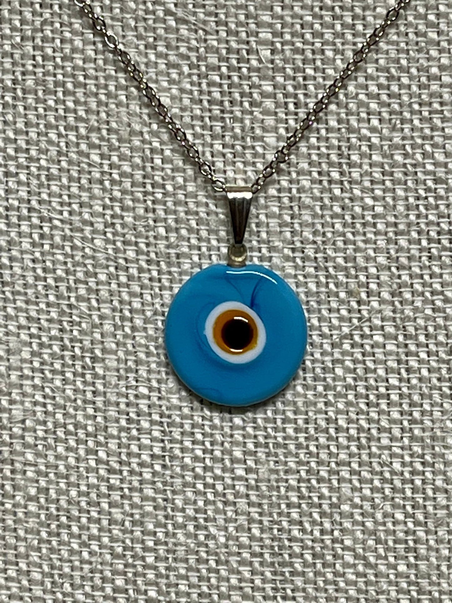 Blue evil-eye pendant necklace with silver chain and round glass charm