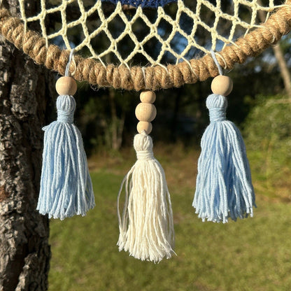 Macrame tassel accents with blue and white beads on evil eye wall hanging