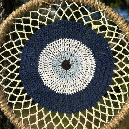 Round macrame evil eye wall hanging with navy and white concentric pattern
