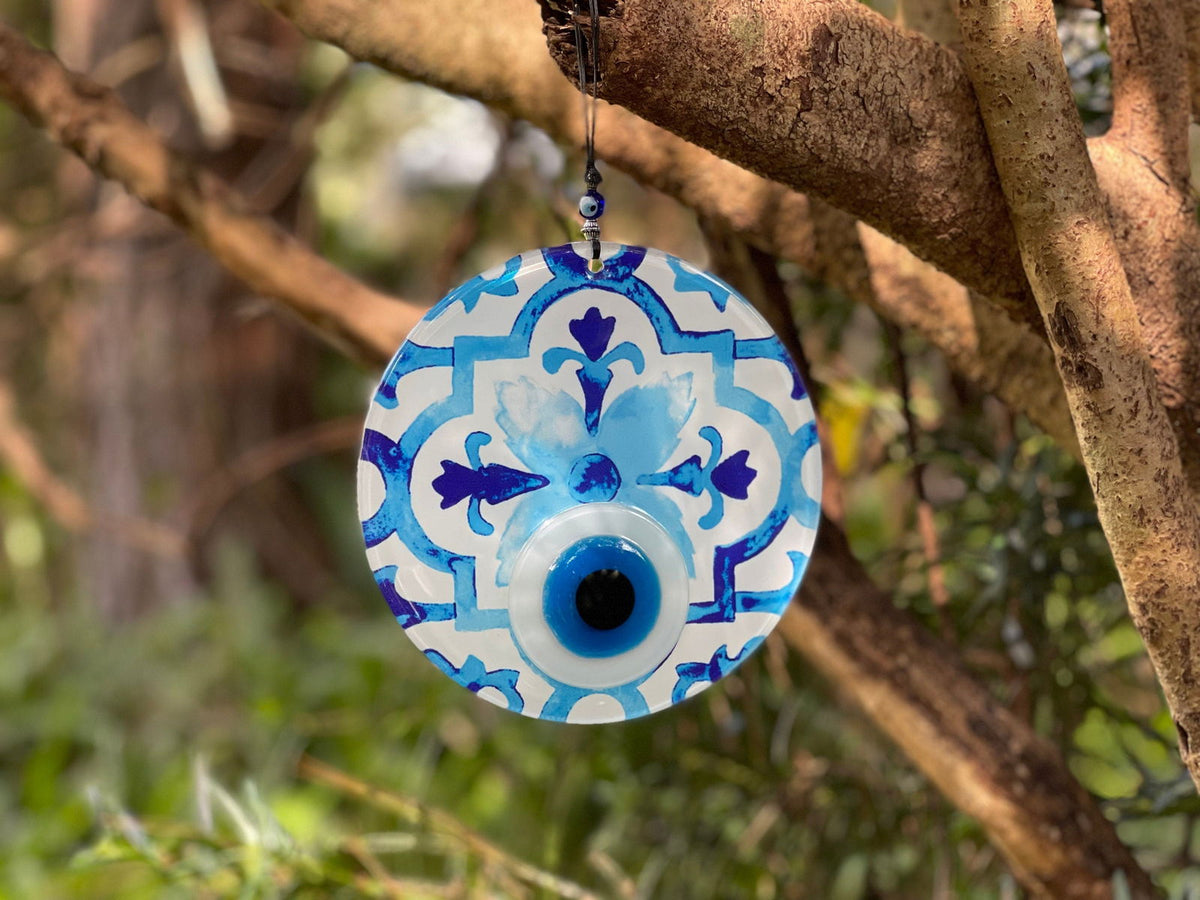 Evil eye wall hanging with blue decorative tile pattern and dark blue center eye.