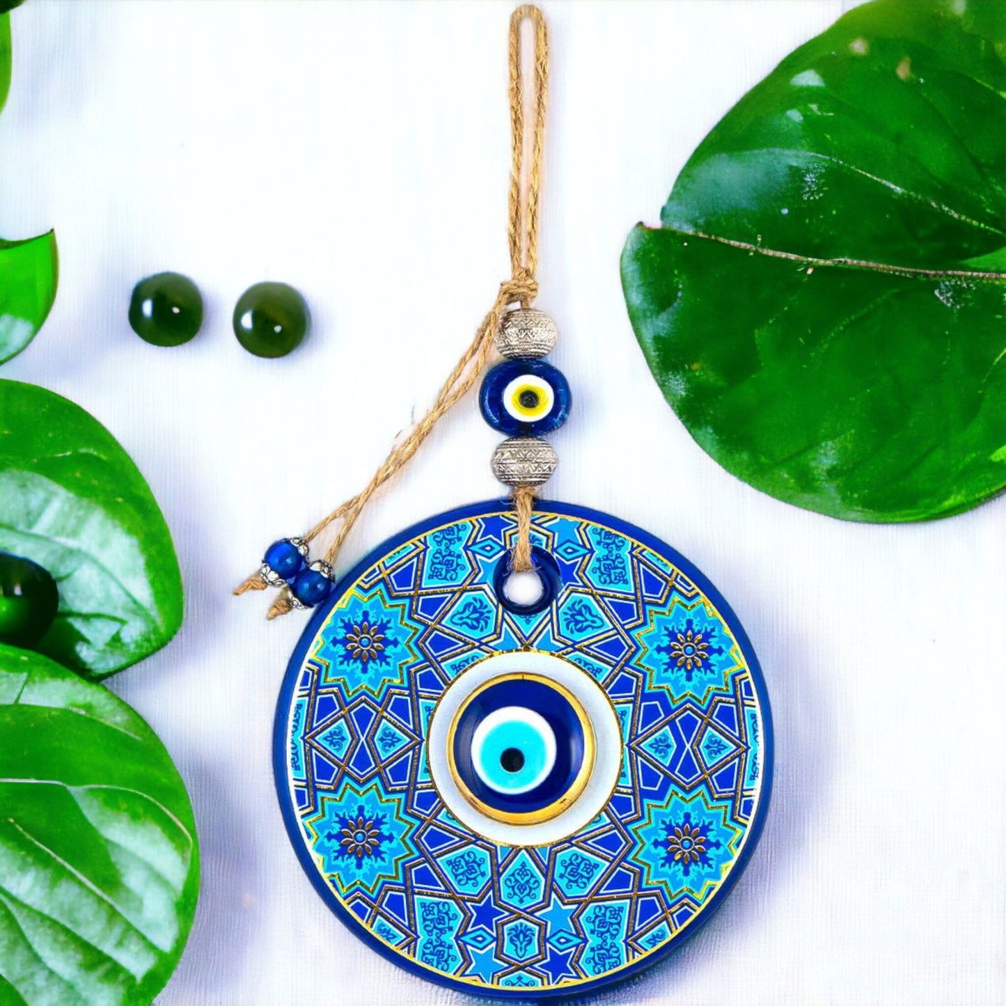Round blue and gold evil-eye wall hanging with bead tassel and hanging string
