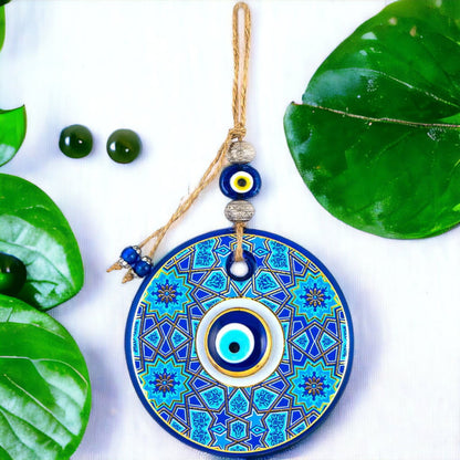 Round blue and gold evil-eye wall hanging with bead tassel and hanging string