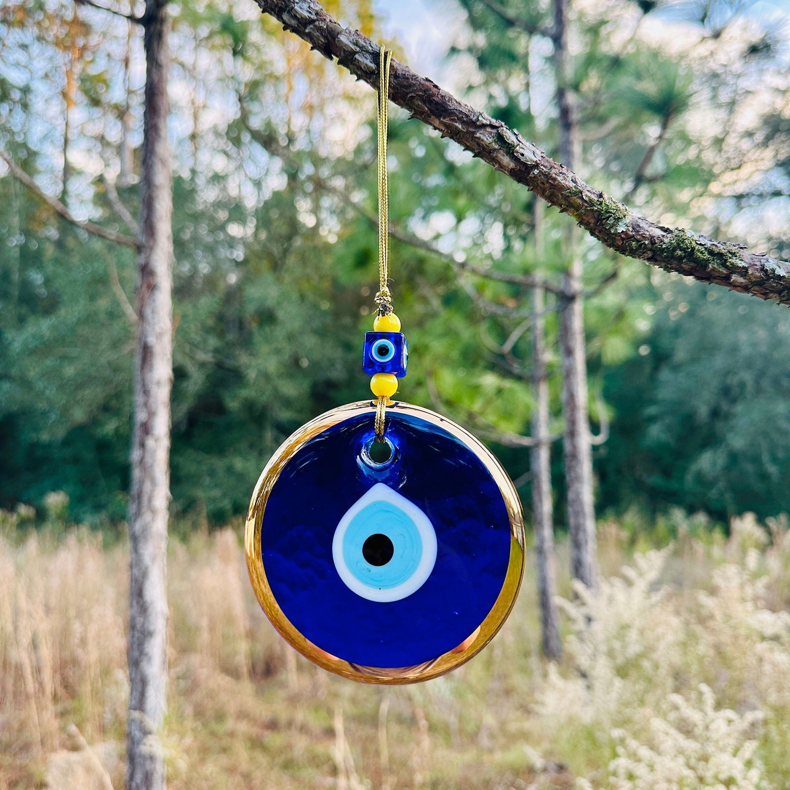 Gold and blue evil eye wall hanging charm with hanging loop cord