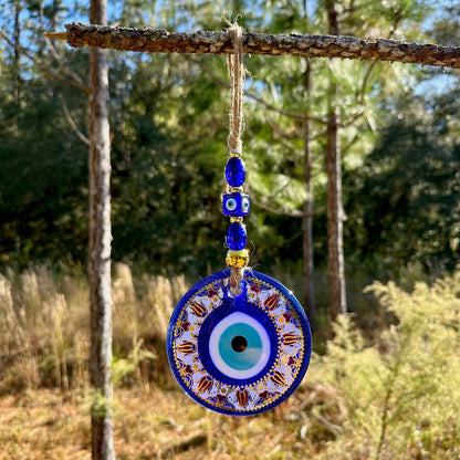 Blue evil eye wall hanging with round mandala disc and gold-trim bead chain