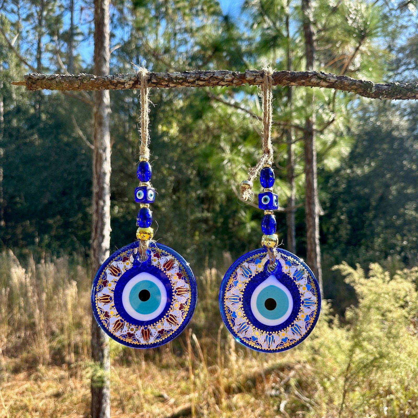 Blue evil eye wall hanging with round mandala charm and gold-trim beads, two discs