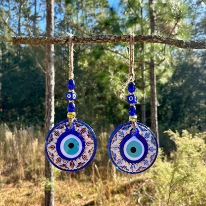 Blue evil eye wall hanging with round mandala charm and gold-trim beads, two discs