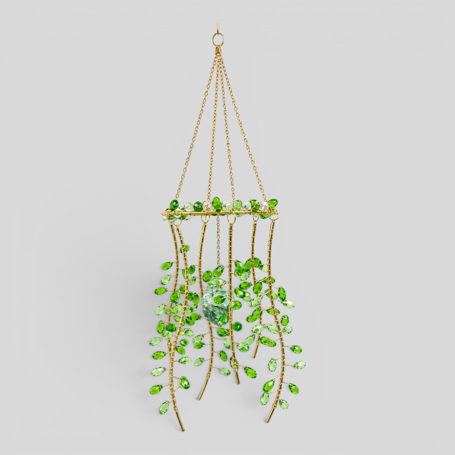 Hanging gold metal suncatcher with green faceted beads and a clear centerpiece