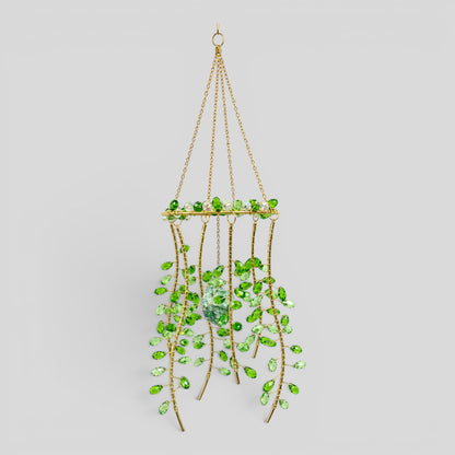 Hanging gold metal suncatcher with green faceted beads and a clear centerpiece