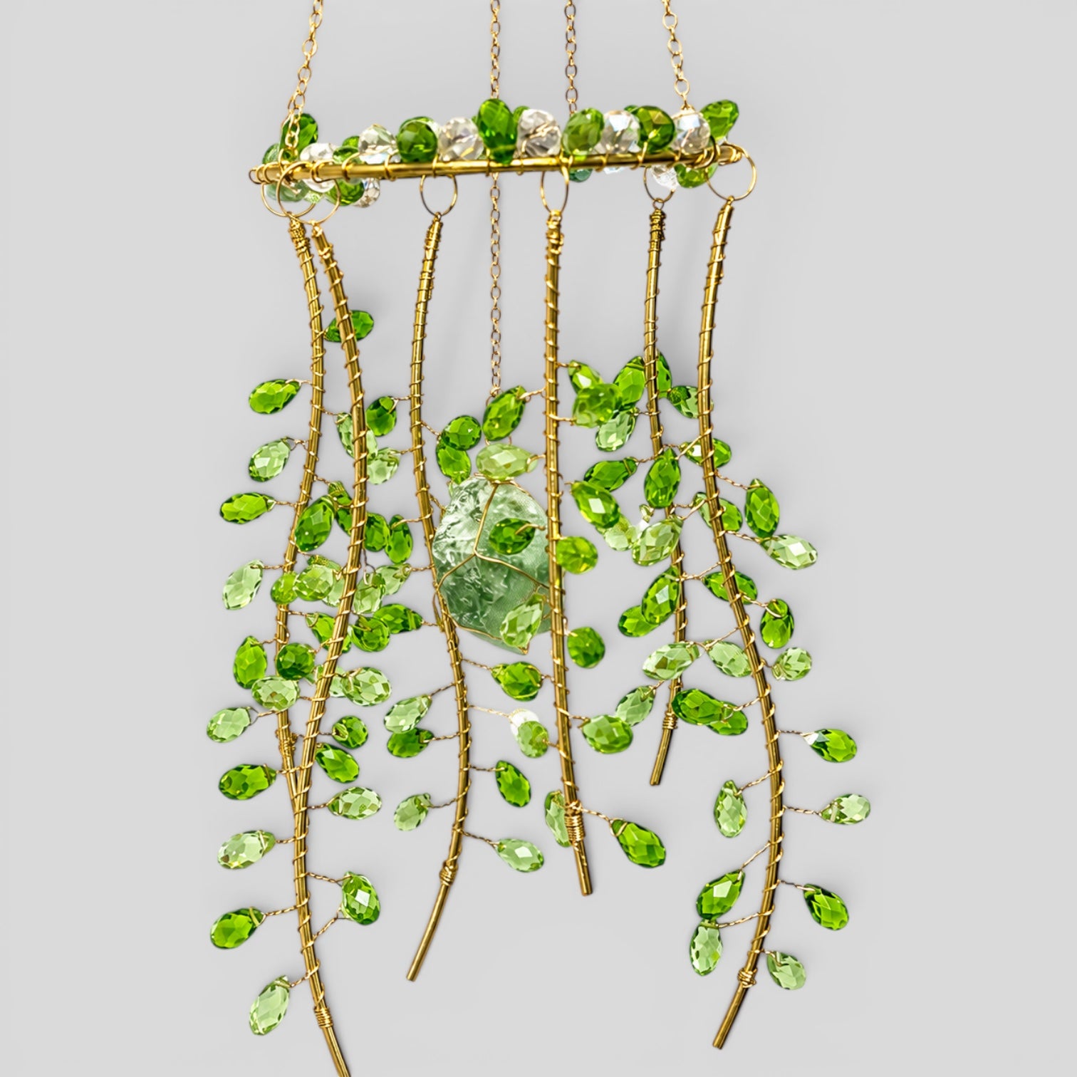 Hanging gold suncatcher with green faceted beads and multiple dangling metal strands