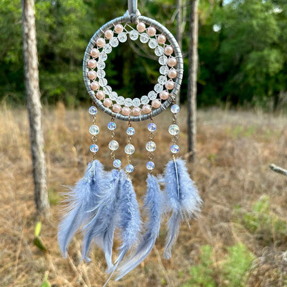 Round dreamcatcher with grey hoop, bead fringe and blue-grey feathers